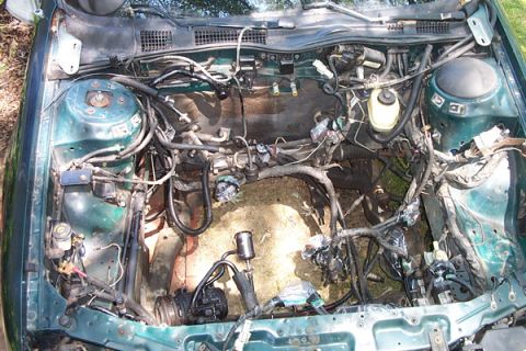 1995 Ford Taurus - Engine bay stripped bare, showing wiring harness and components, ready for refresh or swap.