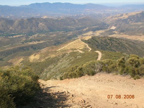 1985 Ford Bronco - A scenic view of a mountainous terrain with a dirt road snaking through the hills, dated 07.08.2006.