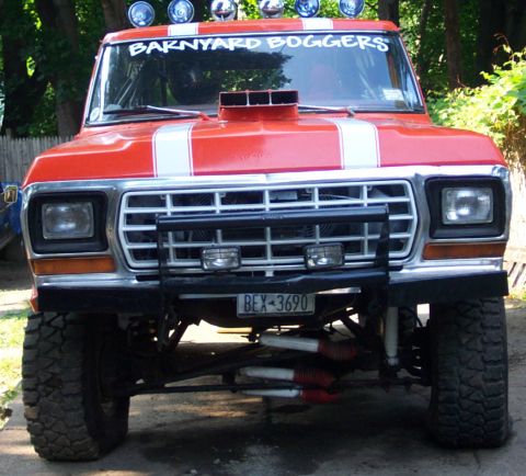1978 Ford Bronco - This modified 1978 Ford Bronco features a prominent snorkel, racing stripes, and lifted suspension for off-road use.