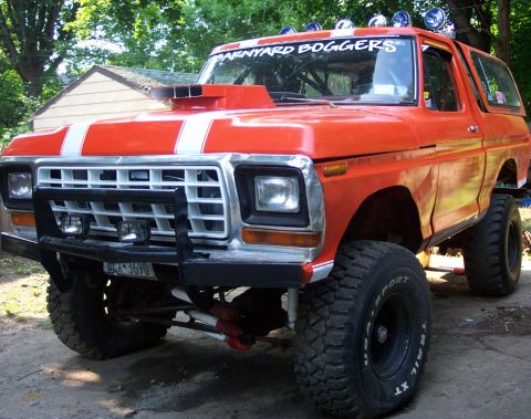 1978 Ford Bronco - Modified 1978 Ford Bronco with custom hood scoop and racing stripes, seen from a 3/4 front angle.