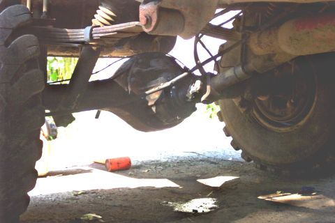 1978 Ford Bronco - Close-up view of the rear axle and suspension system of a vehicle, with leaf springs visible.