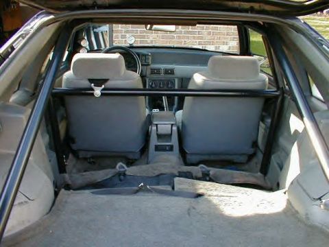 1989 Ford Mustang - Interior view of a 1989 Ford Mustang, equipped with a roll cage and racing seats.