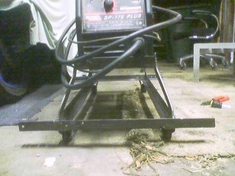 1989 Ford Bronco - A welding machine is positioned on a cart in what appears to be a workshop or garage setting.