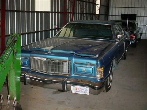 1972 Ford Ranchero - A blue 1977 Mercury sedan is parked inside a garage, with another vehicle visible behind it.
