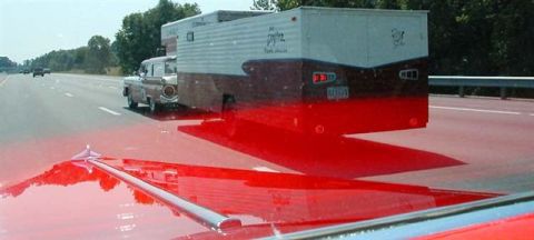 1972 Ford Ranchero - A 1957 Ford Ranchero tows a camper trailer down the highway, viewed from the perspective of another vehicle.