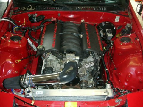 1972 Ford Ranchero - Custom engine swap a Corvette engine in a red vehicle's engine bay.