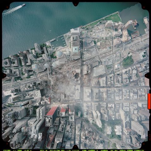 1972 Ford Ranchero - An aerial perspective captures the devastation at Ground Zero, with smoke rising from the rubble and surrounding city blocks impacted.