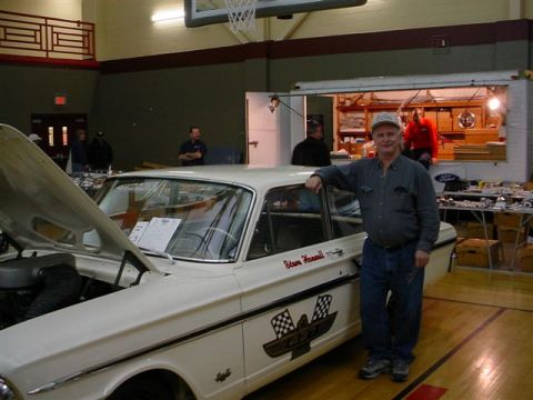1972 Ford Ranchero - A man poses with a white vintage car that has a racing-themed decal on its side.