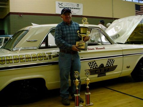 1972 Ford Ranchero - Man with trophies poses with a classic 1964 Ford Thunderbolt, identified by its distinctive badging and body style.