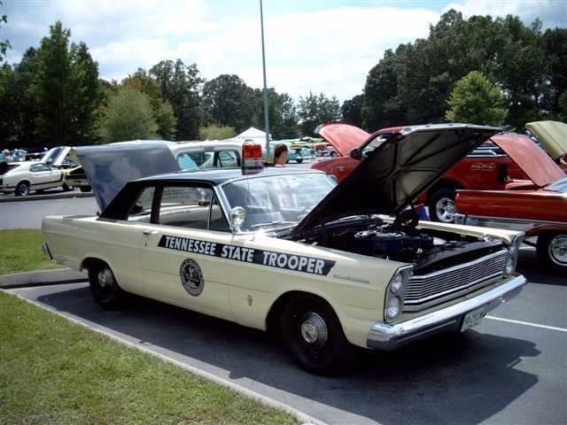 1965 Ford Custom police car with 'TENNESSEE STATE TROOPER' text on the side