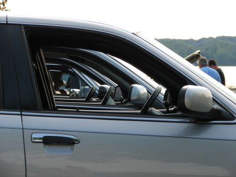 2003 Ford Crown Victoria - Multiple silver sedans, identified as 2003 Ford Crown Victorias, are lined up side-by-side.