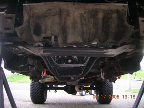 1996 Ford Bronco - Vehicle is lifted, showing suspension components and exhaust system.
