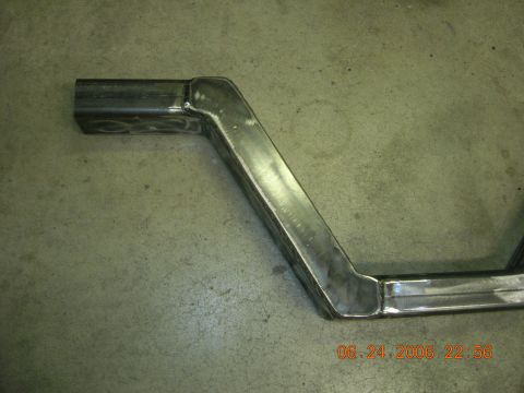 1996 Ford Bronco - Close-up of custom metal tubing, likely a fabricated part, resting on a concrete surface.