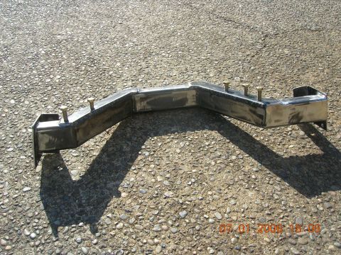1996 Ford Bronco - A custom metal bracket with bolts is shown on an asphalt surface.