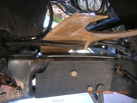 1996 Ford Bronco - Custom metal plate installed on vehicle frame with visible wiring and protective cardboard.