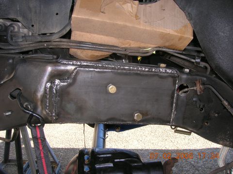 1996 Ford Bronco - Undercarriage view of a vehicle frame showing recent welding and bolted modifications.