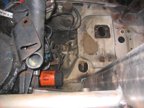 1982 Ford Bronco - Close-up of an engine bay, an oil filter and plumbing components.