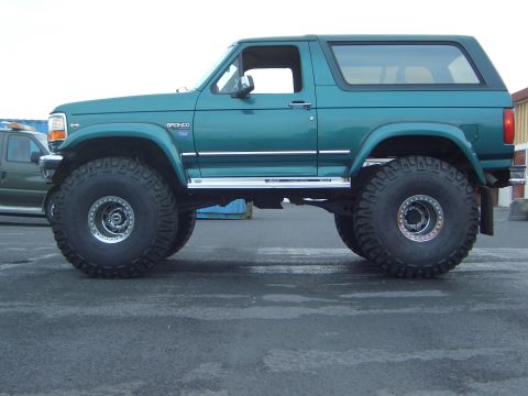 1996 Ford Bronco - This modified 1996 Ford Bronco features a lifted suspension and large off-road tires, giving it an aggressive stance.