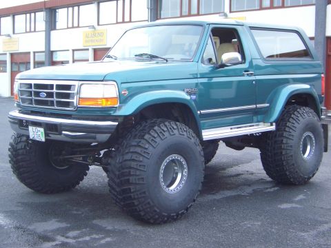 1996 Ford Bronco - This modified 1996 Ford Bronco sits high on massive off-road tires, its lifted suspension and custom grille.