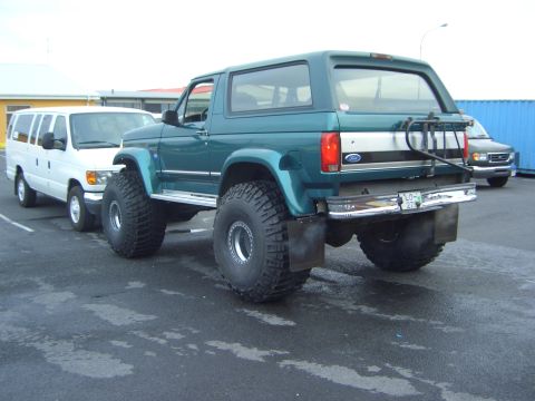 1996 Ford Bronco - Modified 1996 Ford Bronco large off-road tires and a rear-mounted spare tire carrier.
