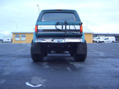 1996 Ford Bronco - This Ford Bronco is seen from the rear, a spare tire carrier and large off-road tires.