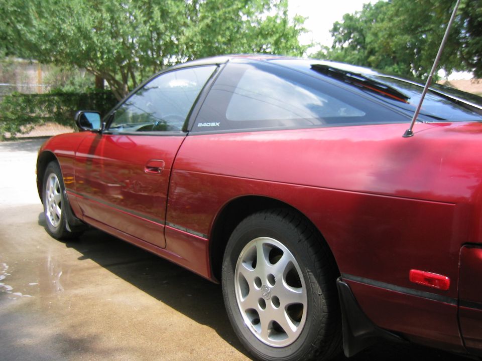 Red 1991 Nissan 240SX coupe, side view, with '240SX' badging