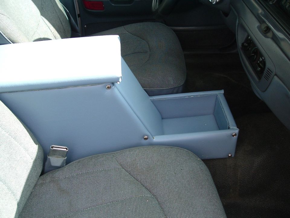 Aftermarket light blue center console with open storage compartment between car seats