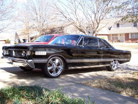 1966 Mercury Monterey - Black 1966 Mercury Monterey coupe with custom chrome wheels parked outside.