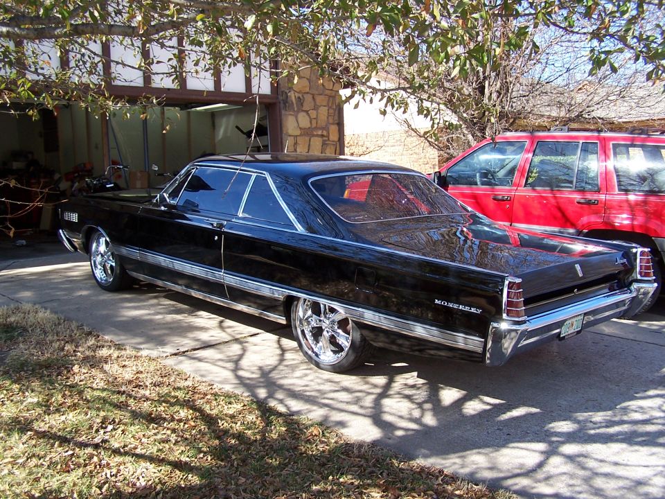 Black 1966 Mercury Monterey hardtop rear three-quarter view in a driveway