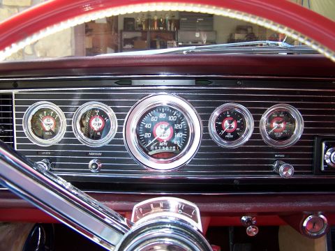 1966 Mercury Monterey - Close-up of a car's interior dashboard, showing various gauges and part of the steering wheel.