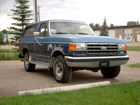 1990 Ford Bronco - This 1990 Ford Bronco is shown from the front three-quarter view, parked outdoors.