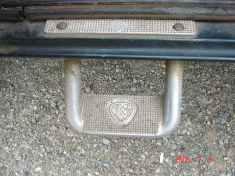1993 Ford Bronco - Close-up of a vehicle's side step bar, showing the 'CARR' emblem and textured surface.