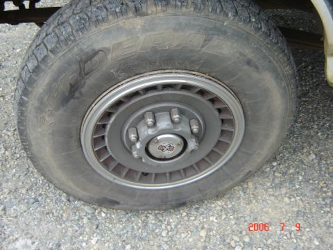 1993 Ford Bronco - A close-up shows a tire and wheel assembly with a "4x4" emblem on the hub.