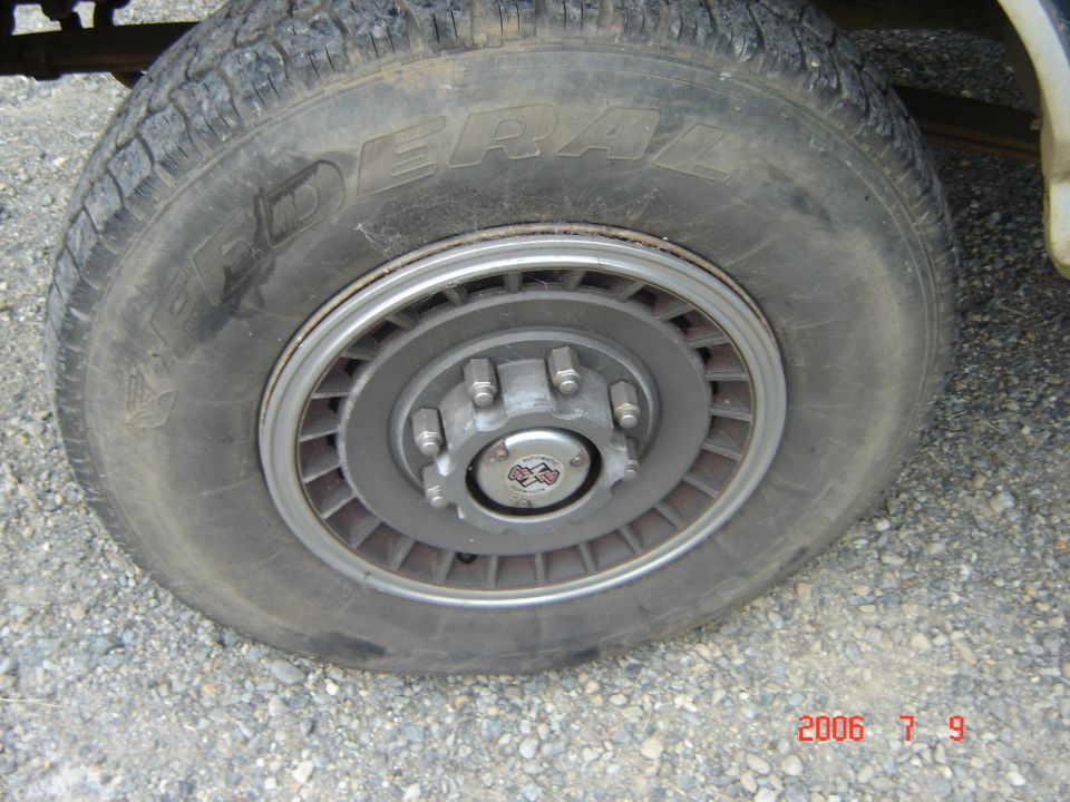 Close-up of a tire and wheel with a "4x4" center cap