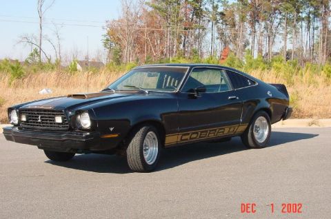 1977 Ford Mustang II - A black 1976 Ford Mustang II Cobra II coupe is shown from the front three-quarter view.