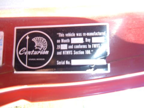 1985 Ford F-150 - A close-up of a Centurion re-manufactured vehicle sticker is visible on a red surface.