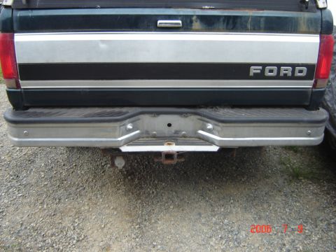 1993 Ford Bronco - Rear view of a Ford truck, showing the tailgate and chrome bumper with a trailer hitch.