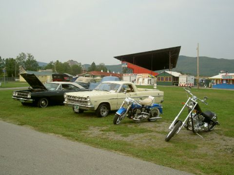 1967 Ford Ranchero - A collection of vehicles, including a 1966 Ford Ranchero, are displayed outdoors on a grassy area.