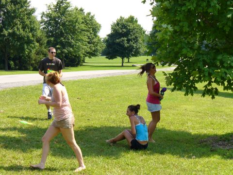 1991 Ford Probe - A group of people enjoy a sunny day in a park, with one person's shirt displaying a date.