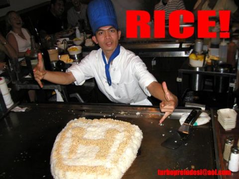 1977 Ford Mustang II - A chef gestures towards a large mound of rice decorated with a Honda emblem.