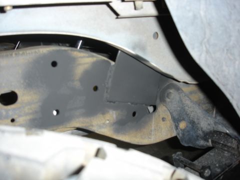 1996 Ford Bronco - Close-up of a custom rear shock mount bracket welded to a vehicle's frame.