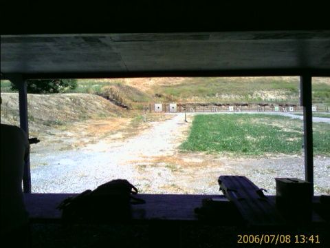 1990 Ford Bronco - A view from a covered shooting range overlooks targets and a grassy area.