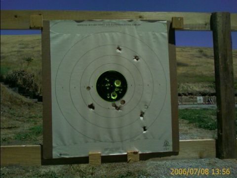 1990 Ford Bronco - Target practice outdoors with a B-27 target showing multiple bullet impacts.