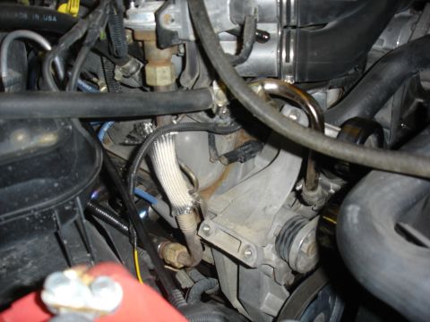1996 Ford Bronco - Old alternator out. No modification to the bracket is necessary. This is a direct bolt on modification.