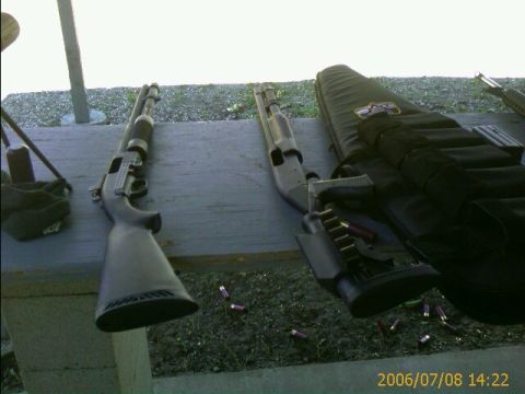 1990 Ford Bronco - Shotguns and ammunition laid out on a table at what appears to be a shooting range.