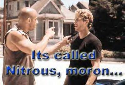 1977 Ford Mustang II - A scene from a movie features two men in an intense discussion, with a prominent text overlay stating 'Its called Nitrous, moron...'