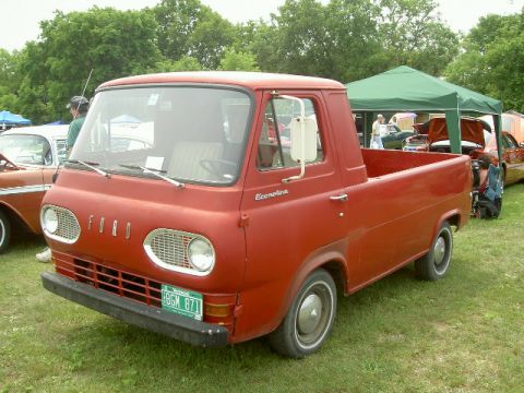 1967 Ford Ranchero - This red Ford Econoline pickup truck is parked outdoors, with other vehicles and a tent visible.