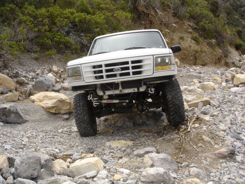 1996 Ford Bronco - This 1996 Ford Bronco is shown tackling a challenging rocky terrain, demonstrating its off-road capabilities.