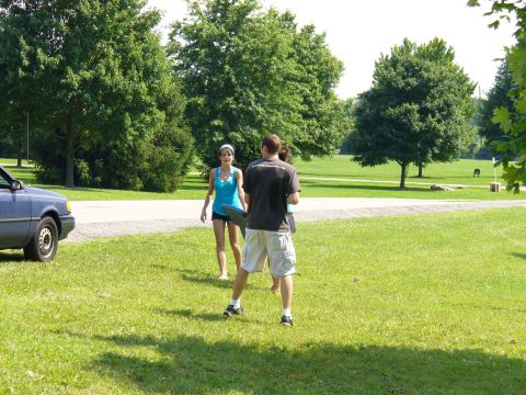 1991 Ford Probe - A blue sedan is parked on a grassy area with two people in the background.