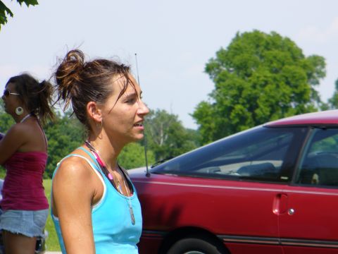 1991 Ford Probe - A woman stands next to a red car, with another woman in the background.